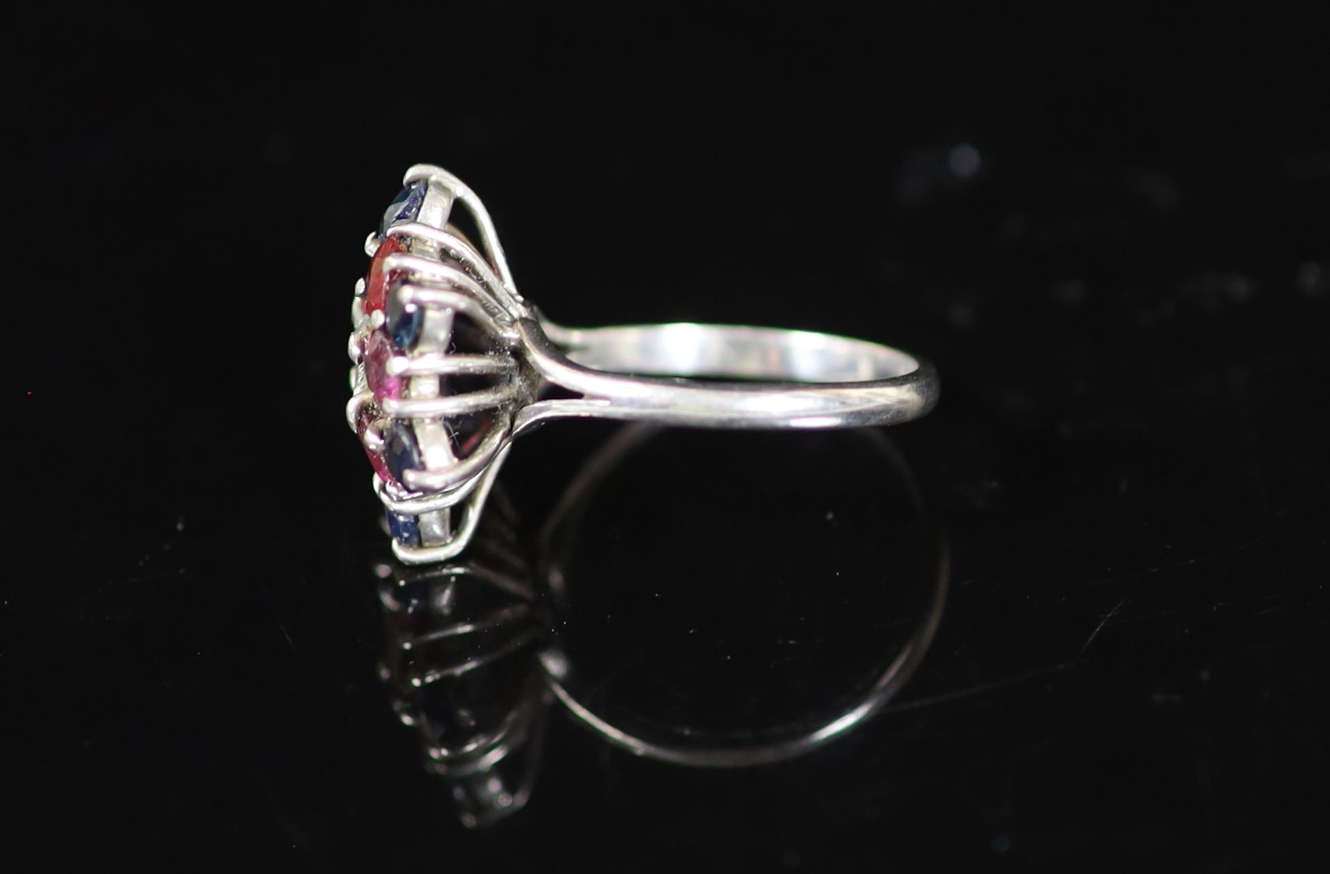 A mid 20th century platinum, ruby, sapphire diamond and amethyst cluster dress ring